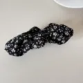 Close-up of retro floral bow hair clip with black fabric and white flower pattern - Banana Clip (Black Floral Bow) / Black