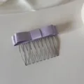 Close-up detail of a soft lilac satin bow hair comb for elegant princess styling. - Bow Hair Comb / Purple