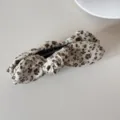 Close-up shot of a vintage floral pattern bow hair clip showing detailed fabric texture - Banana Clip (Beige Floral Bow)