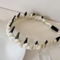 Close-up of plaid wrapped headband with black spikes and lace detail - Yellow Plaid Wavy Headband