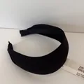 Close-up of a premium black thickened wide-brimmed headband with elegant striped texture detail. - Black Wide Headband