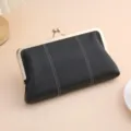 Elegant black lychee grain leather clutch bag featuring a vintage gold-tone kiss lock frame - Black