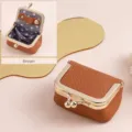 Mini brown genuine leather jewelry pouch with kiss-lock clasp and polka dot lining - Brown