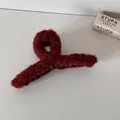 Detailed macro view of burgundy plush shark hair clip showing soft fuzzy texture detail - Red Plush Claw Clip