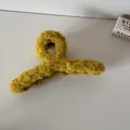 Detailed macro shot showing the soft fuzzy texture of the yellow plush shark hair clip - Yellow Plush Hair Claw