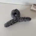 Detail of a grey fuzzy plush hair claw clip showing soft texture and sturdy design. - Grey Plush Hair Claw