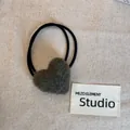 Detail of a plush grey heart-shaped hair tie on a minimalist textured linen background. - Dark Green Heart Hair Tie