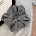 Macro detail of a fuzzy grey scrunchie with sparkling gold thread accents. - Gray Gold Silk Scrunchie
