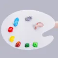 Close-up of white oval artist palette with vibrant wet paint blobs for acrylic and oil painting - Oval / 15*25cm / White