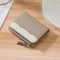 Taupe and white color-block leather wallet with zipper detail on wood - Elephant Gray
