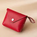 Compact red pebbled leather coin purse for women with wrist strap and snap closure - Red