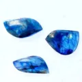 Close-up of three labradorite stones with vibrant blue labradorescence on white background. - Labradorite Pendant (Irregular Shape) / Approx. 2.5-3.5cm