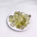Assorted natural crystal round beads for DIY jewelry making displayed on a small white plate - Yellow