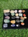 Detailed view of polished natural tumbled crystals and gemstones on black cloth - Approx 20-25mm / 23 Pieces/Pack