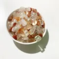 Assorted natural crystal tumbled stones in a white ceramic bowl for home decoration - Red Hematoid Quartz / 100g Pack