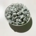 Polished natural light green spotted kiwi jasper crystal crushed stones in a white bowl - Tianshan Blue / 100g Pack