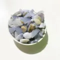 Polished natural blue lace agate tumbled stones presented in a white decorative bowl - Blue Chalcedony / 100g Pack