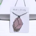 Rose quartz crystal pendant necklace with silver geometric metal net cage variant. - Rose Quartz / Net Pocket Necklace