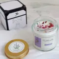 Handmade lavender scented soy wax candle in glass jar with purple label and gold lid. - Lavender