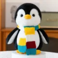 Cute cartoon penguin plush toy wearing a vibrant multi-colored knitted scarf for gift - Scarf Penguin-Yellow