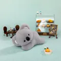 Cuddly grey plush koala toy lying down in a cute miniature bakery setting for gift - 18cm / Little Koala