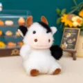 Portachiavi mini peluche a forma di mucca con macchie bianche e nere e corna marroni. - 10cm / Mucca