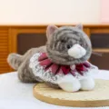 Realistic grey tabby plush cat toy wearing a lace collar and maroon bow on a tray - 43cm / Tabby Cat