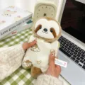 Adorably soft sloth plush pouch featuring a cute cartoon dog print held by hand - Sloth