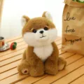 Cute brown and white sitting plush dog toy with soft fluffy fur and heart detail - Akita / 18cm