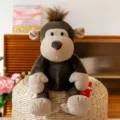Adorabile peluche di scimmia marrone scuro con accenti beige e ciuffo di capelli - Scimmia