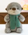 Adorable gray otter plush toy wearing a vibrant green knitted scarf, soft stuffed animal gift. - Otter with Scarf / 26cm