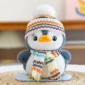 Plush penguin doll variant with grey fur and a colorful knitted hat and scarf - Skiing Style / 15cm
