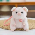 Adorable pink plush pig keychain charm featuring a small strawberry bunny accessory - Pig Pendant