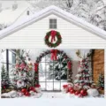 Large Christmas garage door banner featuring a snowy house and decorated trees scene - Snowy Cabin with Red Bow (CK-006) / 400x180cm
