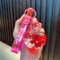 Süßer rosa Apfel Flüssigkeit Treibsand Schlüsselanhänger Taschenanhänger mit Glitzer - Fuchsia