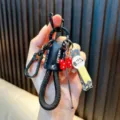 Multifunctional black woven rope car keychain with nail clipper and red bow charm - Black