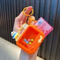 Orange mini claw machine keychain decompression toy featuring a cute penguin mascot - Orange Claw Machine (Penguin Theme) / Orange
