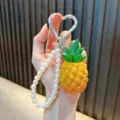 Realistische ananas sleutelhanger met witte parelband en zilveren hartkarabijnhaak - Simulatie Ananas / Ananas