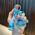Blue liquid-filled fish keychain with glitter and Just Keep Doing It strap. - Blue