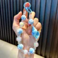 Blauwe schelp kralen telefoonketting met iriserende aurora kralen voor tassen decoratie - Blauw / Inclusief Pakking