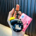 Black snail shaped keychain with cute cat illustration and a pink boutique tag - Musical Snail / Black