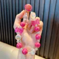 Handmade beaded crystal phone chain featuring pink bowknots and glossy iridescent beads - Rose Red