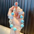 Blue pearly beaded phone charm with crystal bows and a matching blue spring clasp - Blue