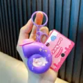 Vibrant purple musical snail keychain with a cute pig illustration and pink hat detail - Musical Snail / Purple