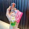 Green liquid oil-filled sneaker keychain with star glitter and silver bell charm - Green