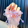 Violetter perlenbesetzter Schmetterling Schlüsselanhänger und Handykette mit Kristallen - Funkelnder Schleifenanhänger / Inklusive Handy-Dichtung / Lila