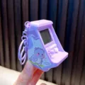 Purple mini arcade machine keychain with cute cartoon dinosaur illustration for kids - Purple