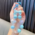Handmade iridescent blue beaded phone charm featuring stylish bow and heart pendants - Blue (Without Gasket)