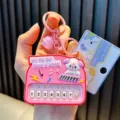 Pink cartoon toy piano keychain with musical note patterns and mini keys - White Dog Piano / Pink