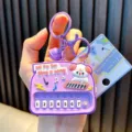 Cute purple mini toy piano keychain featuring a cartoon dog and white numbered keys. - White Dog Piano / Purple